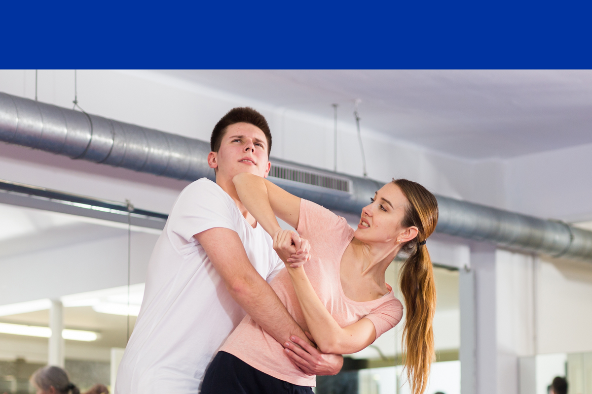 A woman elbow striking a man trying to grab her