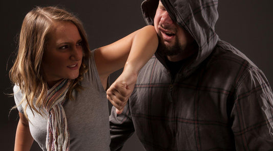woman elbowing attackers face