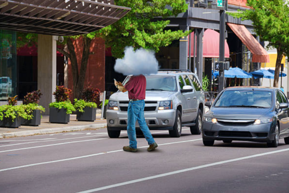 a man crossing the street with a cloud over his head