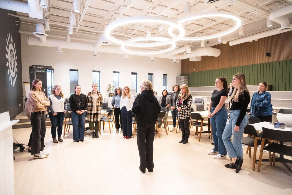 Group of employees standing and listening during a Power Up with Lisa self-defense class