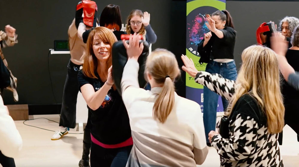 Group of people participating in a self-defense corporate class 