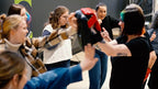 Group of people practicing uppercut self-defense moves