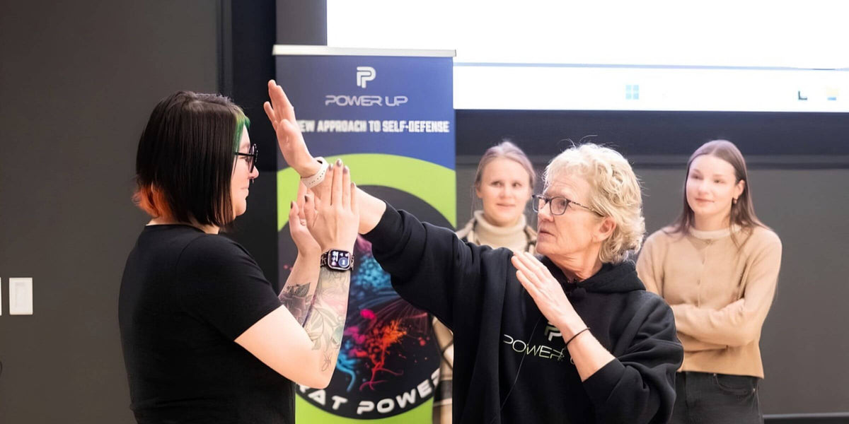 Lisa Davis demonstrating a self-defense move with a student