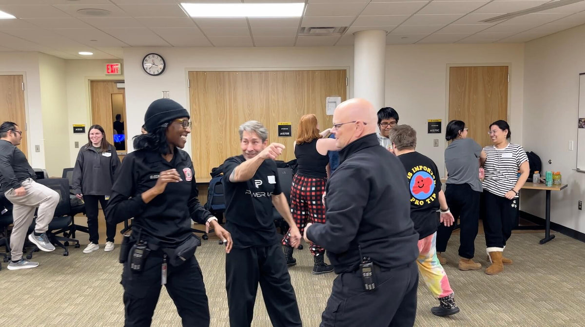 Power Up with Lisa co-instructor demonstrating a strike with campus safety officers