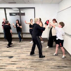 Lisa Davis instructing a 13 year old boy how to slap strike for self-defense