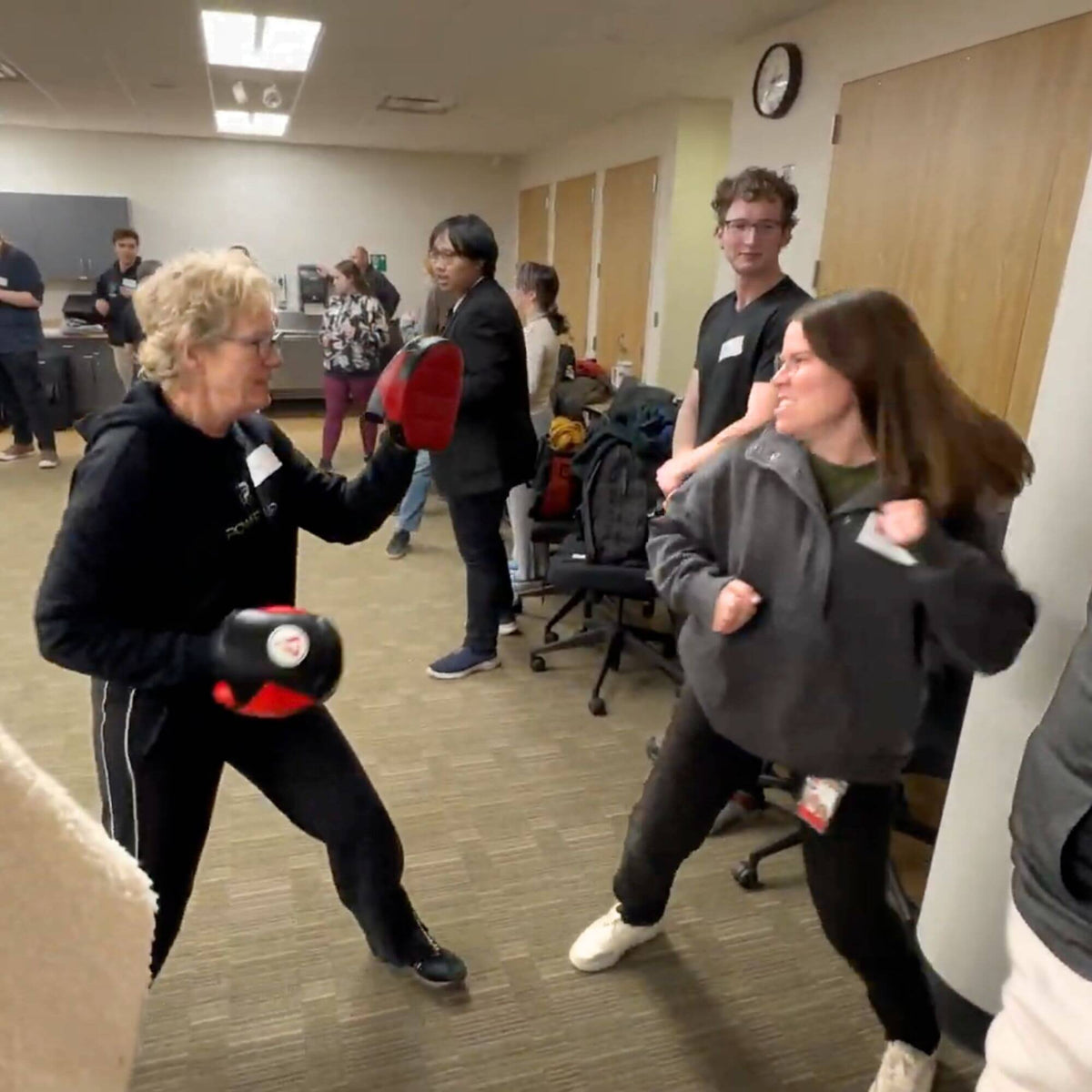 Two people practicing self-defense moves in a self-defense class