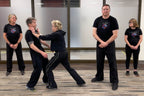 Group of people practicing self-defense moves with Lisa Davis