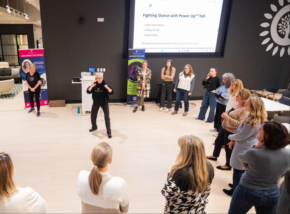 Group of people in a room with a self-defense presenter 