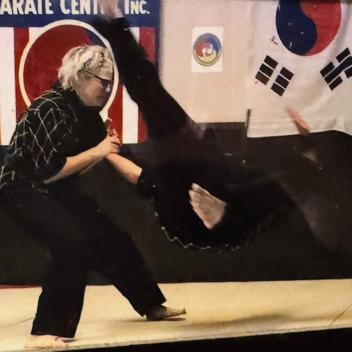 Lisa Davis in a martial arts pose flipping her component over