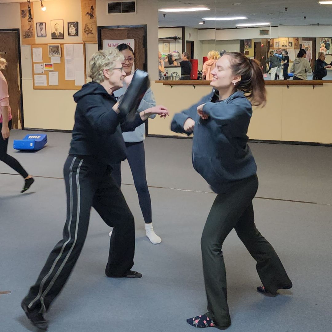 Lisa training a student in self-defense