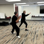 Lisa Davis instructing a student how to push back and create distance for protection